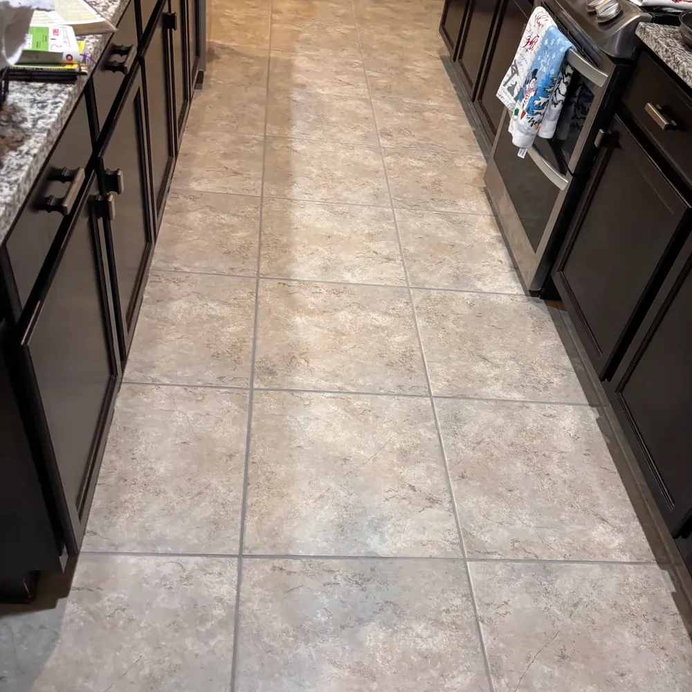 Clean tile kitchen floor with grout lines after professional cleaning