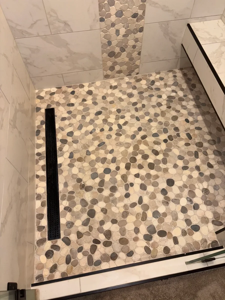 Pebble shower floor with cleaned grout
