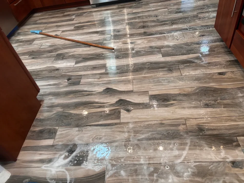 Cleaning solution dwelling on a wood-look tile floor before extraction
